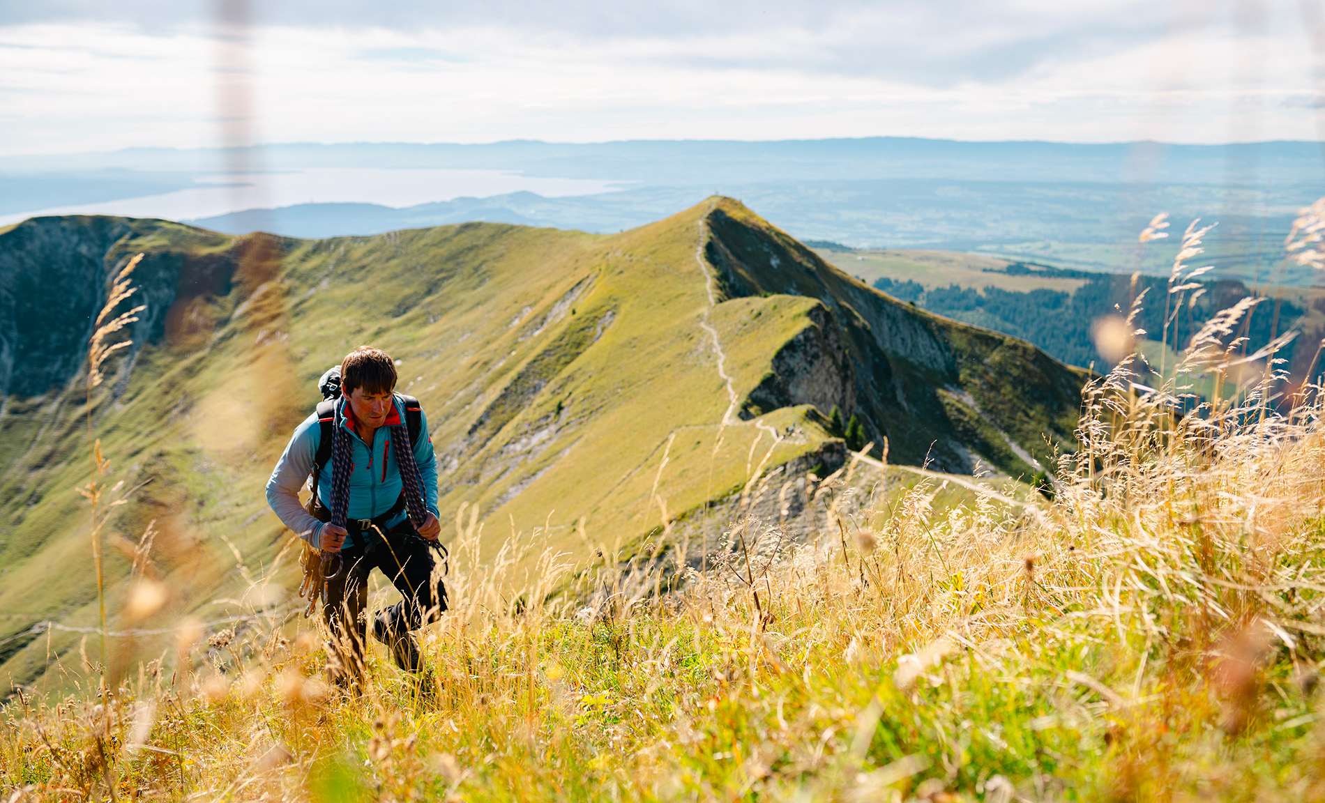 Hiker on mountain ridge with scenic landscape